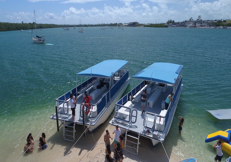 A boat party in Miami at the famous Monument Island on two party boats with floats and toys.