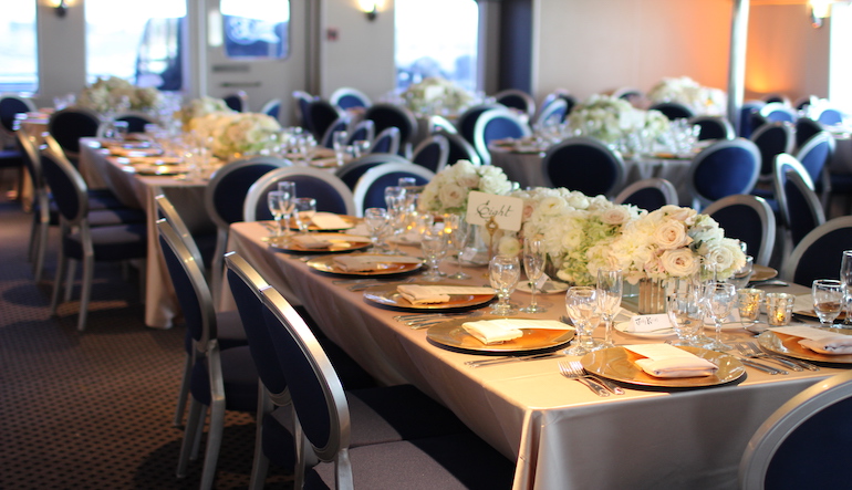 A Miami corporate event table setting on a luxury yacht rental.