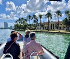 A group enjoys a speed boat tour in miami to see Star Island and the celebrity mansions.