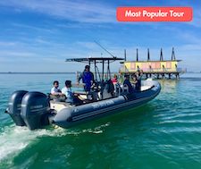 Miami visitors enjoying a day on a tour by boat to see the Stiltsville houses.