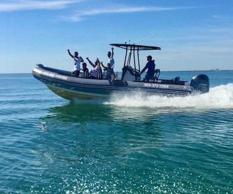 Group of guys enjoy a Miami speed boat tour on Biscayne Bay.
