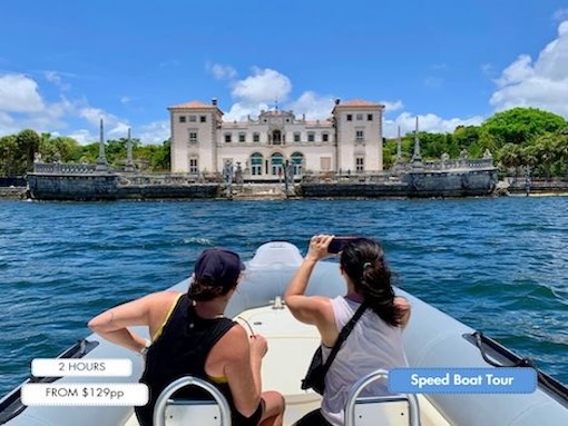 A couple visit Vizcaya Museum & Gardens from the water on a speed boat tour in Miami.