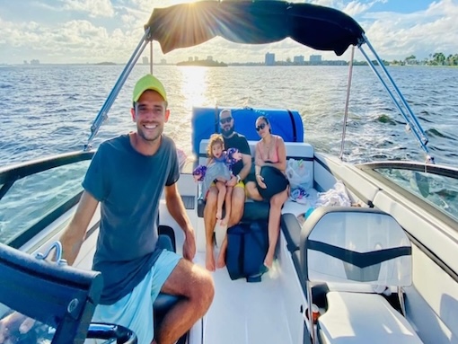 Miami boat A group of friends enjoy a boat rental in Miami and swim in the bay.
