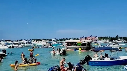 Party goers at Haulover Sandbar in Miami on Jet Skis and boats in the Florida sun.