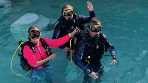 A group of people take a scuba certification course to learn how to scuba dive in a beginner scuba diving lesson in Miami.