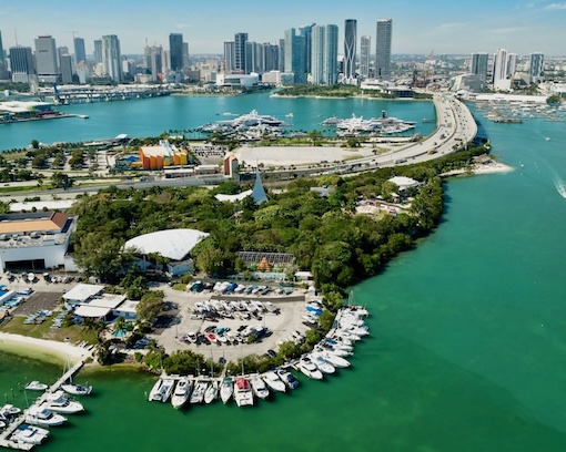 An aerial shot of the zip line obstacle course with downtown Miami skyline in background.